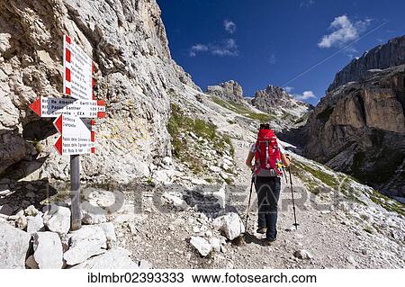 "Hiker climbing Kesselkogel mountain, walking near Rifugio Preuss mountain lodge and Rifugio Vaiolet mountain lodge, Rosengarten group, province of Trentino, Italy, Europe" View Large Photo Image Stock Image - "Hiker climbing Kesselkogel mountain, walking near Rifugio Preuss mountain lodge and Rifugio Vaiolet mountain lodge, Rosengarten group, province of Trentino, Italy, Europe". Fotosearch