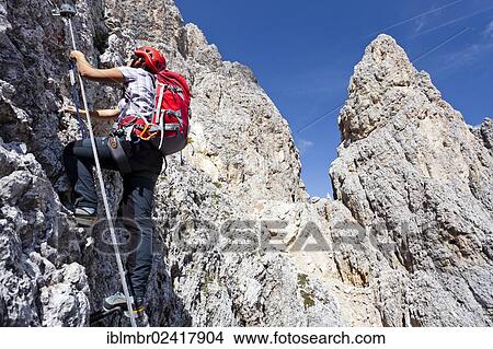 Hiker climbing to the summit of Plattkofel mountain, here on the Oskar Schuster Stieg trail, fixed rope route, Dolomites, province of Bolzano-Bozen, Italy, Europe View Large Photo Image Picture - Hiker climbing to the summit of Plattkofel mountain, here on the Oskar Schuster Stieg trail, fixed rope route, Dolomites, province of Bolzano-Bozen, Italy, Europe. Fotosearch