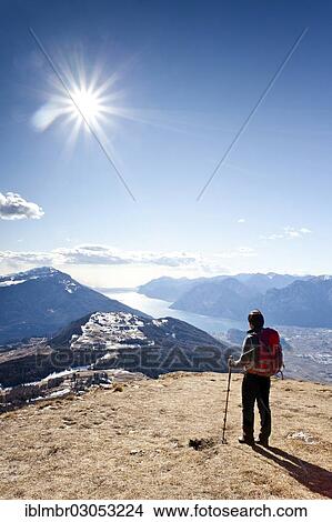 "Hiker during the ascent of Monte Stivo, Lake Garda with the village of Riva at back, Alpen, Trentino Province, Trentino-Alto Adige, Italy, Europe" View Large Photo Image Picture - "Hiker during the ascent of Monte Stivo, Lake Garda with the village of Riva at back, Alpen, Trentino Province, Trentino-Alto Adige, Italy, Europe". Fotosearch