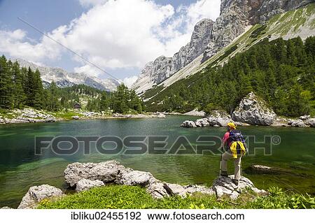 "Hiker looking towards Koca pri Triglavskih jezerih, Seven Lakes hut, Triglav National Park, Slovenia, Europe" View Large Photo Image Stock Image - "Hiker looking towards Koca pri Triglavskih jezerih, Seven Lakes hut, Triglav National Park, Slovenia, Europe". Fotosearch