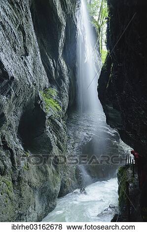 "Hiker observing a waterfall in the Partnachklamm gorge, Reintal, Upper Bavaria, Bavaria, Germany, Europe" View Large Photo Image Stock Photo - "Hiker observing a waterfall in the Partnachklamm gorge, Reintal, Upper Bavaria, Bavaria, Germany, Europe". Fotosearch