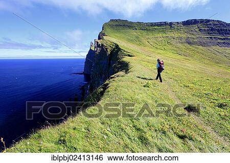 Hiker on a cliff near Hornstrandir, Westfjords, Iceland, Europe View Large Photo Image Stock Photograph - Hiker on a cliff near Hornstrandir, Westfjords, Iceland, Europe. Fotosearch