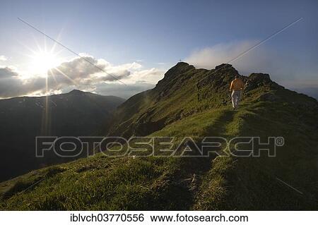 "Hiker on the summit of Mt Grosser Galtenberg in the evening light, Alpbachtal valley, Tyrol, Austria, Europe" View Large Photo Image Stock Photograph - "Hiker on the summit of Mt Grosser Galtenberg in the evening light, Alpbachtal valley, Tyrol, Austria, Europe". Fotosearch