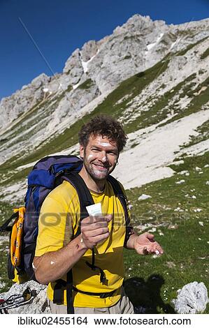 "Hiker reapplying sunscreen, Triglav National Park, Slovenia, Europe" View Large Photo Image Picture - "Hiker reapplying sunscreen, Triglav National Park, Slovenia, Europe". Fotosearch