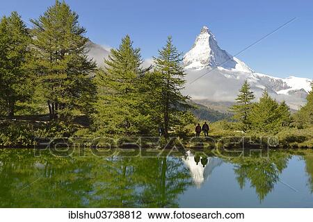 "Hiker standing at Lake Grindjisee, with the Matterhorn at the rear, Zermatt, Canton of Valais, Switzerland, Europe" View Large Photo Image Stock Image - "Hiker standing at Lake Grindjisee, with the Matterhorn at the rear, Zermatt, Canton of Valais, Switzerland, Europe". Fotosearch