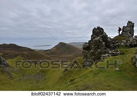 "Hiker standing in a volcanic landscape, Loch Leum na Luirginn, Flodigarry, The Table, Highlands, Isle of Skye, Scotland, United Kingdom, Europe" View Large Photo Image Stock Image - "Hiker standing in a volcanic landscape, Loch Leum na Luirginn, Flodigarry, The Table, Highlands, Isle of Skye, Scotland, United Kingdom, Europe". Fotosearch