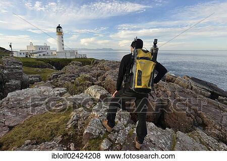 Hiker with a backpack in front of Rua Reidh Lighthouse, Melvaig, Gairloch, Western Ross, Scotland, United Kingdom, Europe View Large Photo Image Stock Photo - Hiker with a backpack in front of Rua Reidh Lighthouse, Melvaig, Gairloch, Western Ross, Scotland, United Kingdom, Europe. Fotosearch