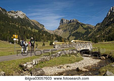 "Hikers at Groenbach stream in front of the summit of Schibe Mountain, bei Pufel im Justistal, Berner Oberland, Canton of Bern, Switzerland, Europe" View Large Photo Image Stock Image - "Hikers at Groenbach stream in front of the summit of Schibe Mountain, bei Pufel im Justistal, Berner Oberland, Canton of Bern, Switzerland, Europe". Fotosearch