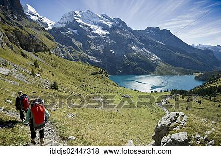 Stock Photo - "Hikers at Oeschinensee, Oeschinen Lake, Bernese Oberland, Canton of Bern, Switzerland, Europe". Fotosearch