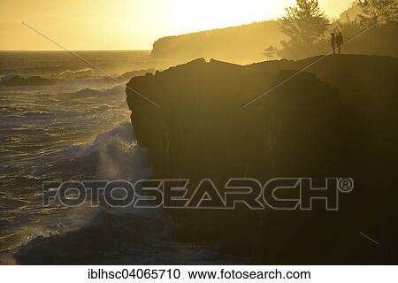 "Hikers at sunset, evening light, volcanic coastline, cliffs, Reunion" View Large Photo Image Stock Image - "Hikers at sunset, evening light, volcanic coastline, cliffs, Reunion". Fotosearch