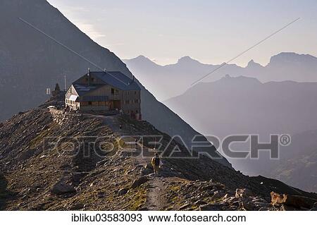 Stock Image - "Hikers at the Cabane de Pannossiere refuge, Val de Bagnes valley, Canton of Valais, Switzerland, Europe". Fotosearch