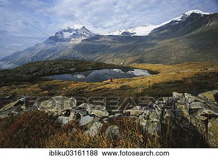 "Hikers at the mountain lake Lac Blanc, Mt Dent Parrachee, Mt Dome de l'Arpont and the Vanoise Glaciers at back, Vanoise Nationalpark, Haute Savoie, France, Europe" View Large Photo Image Stock Photo - "Hikers at the mountain lake Lac Blanc, Mt Dent Parrachee, Mt Dome de l'Arpont and the Vanoise Glaciers at back, Vanoise Nationalpark, Haute Savoie, France, Europe". Fotosearch