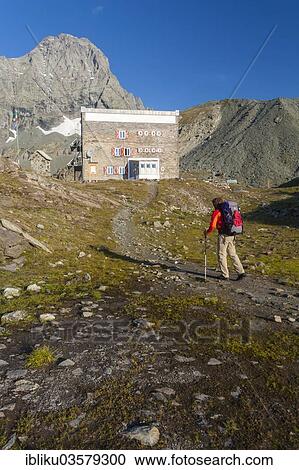 "Hikers at the Rifugio Gastaldi refuge, Mt Uia di Bessanese at back, Lanzo Valleys, Graian Alps, Province of Turin, Piedmont region, Italy, Europe" View Large Photo Image Stock Image - "Hikers at the Rifugio Gastaldi refuge, Mt Uia di Bessanese at back, Lanzo Valleys, Graian Alps, Province of Turin, Piedmont region, Italy, Europe". Fotosearch