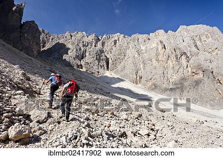 Hikers climbing to the summit of Plattkofel mountain, here walking on the Oskar Schuster Stieg trail, fixed rope route, Dolomites, province of Bolzano-Bozen, Italy, Europe View Large Photo Image Stock Image - Hikers climbing to the summit of Plattkofel mountain, here walking on the Oskar Schuster Stieg trail, fixed rope route, Dolomites, province of Bolzano-Bozen, Italy, Europe. Fotosearch