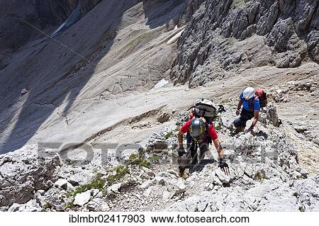 Hikers climbing to the summit of Plattkofel mountain, here on the Oskar Schuster Stieg trail, fixed rope route, Dolomites, province of Bolzano-Bozen, Italy, Europe View Large Photo Image Stock Image - Hikers climbing to the summit of Plattkofel mountain, here on the Oskar Schuster Stieg trail, fixed rope route, Dolomites, province of Bolzano-Bozen, Italy, Europe. Fotosearch