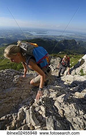 "Hikers climbing to the summit of Kampenwand Mountain, Lake Chiemsee, Chiemgau, Bavaria, Germany, Europe" View Large Photo Image Stock Photo - "Hikers climbing to the summit of Kampenwand Mountain, Lake Chiemsee, Chiemgau, Bavaria, Germany, Europe". Fotosearch