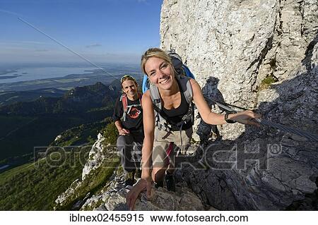 "Hikers climbing to the summit of Kampenwand Mountain, Lake Chiemsee, Chiemgau, Bavaria, Germany, Europe" View Large Photo Image Stock Photography - "Hikers climbing to the summit of Kampenwand Mountain, Lake Chiemsee, Chiemgau, Bavaria, Germany, Europe". Fotosearch