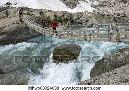 "Hikers crossing a hanging bridge over a glacial river, glacier tongue of Nigardsbreen Glacier, Jostedal, Gletscher Jostedalsbreen, Sogn og Fjordane, Western Norway, Norway, Europe" View Large Photo Image Stock Photo - "Hikers crossing a hanging bridge over a glacial river, glacier tongue of Nigardsbreen Glacier, Jostedal, Gletscher Jostedalsbreen, Sogn og Fjordane, Western Norway, Norway, Europe". Fotosearch