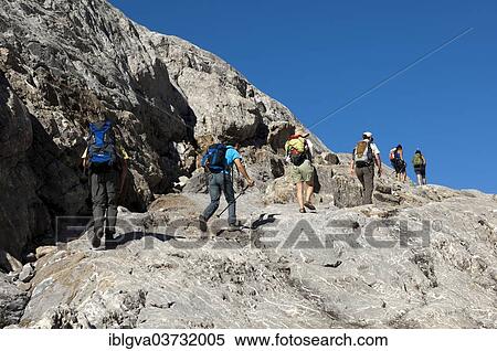 Stock Photography - "Hikers crossing the exposed bedrock of Tsanfleuron Glacier, Canton of Valais, Switzerland, Europe". Fotosearch