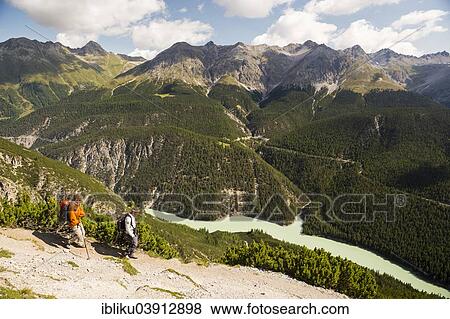 "Hikers descending from Mt Murter into the Spol Valley, Val dal Spol, Swiss National Park, Graubunden, Switzerland, Europe" View Large Photo Image Stock Photo - "Hikers descending from Mt Murter into the Spol Valley, Val dal Spol, Swiss National Park, Graubunden, Switzerland, Europe". Fotosearch