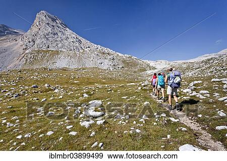"Hikers during the ascent of Piz de Lavarela, Mt La Varella or Lavarella, Fanes-Sennes-Prags Nature Park, Lavarella saddle at the back, Dolomites, South Tyrol, Italy, Europe" View Large Photo Image Stock Photo - "Hikers during the ascent of Piz de Lavarela, Mt La Varella or Lavarella, Fanes-Sennes-Prags Nature Park, Lavarella saddle at the back, Dolomites, South Tyrol, Italy, Europe". Fotosearch