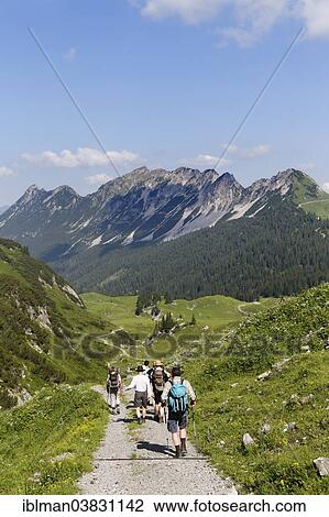 "Hikers hiking above the Laguz Alps and Breithorn Mountain, Grosses Walsertal Biosphere Reserve, Vorarlberg, Austria, Europe" View Large Photo Image Stock Image - "Hikers hiking above the Laguz Alps and Breithorn Mountain, Grosses Walsertal Biosphere Reserve, Vorarlberg, Austria, Europe". Fotosearch
