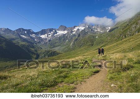 Stock Image - "Hikers in Seewertal valley, mountains Hoher First and Granatenkogel at back, Seewertal, Otztaler Alpen, South Tyrol province, Trentino-Alto Adige, Italy, Europe". Fotosearch