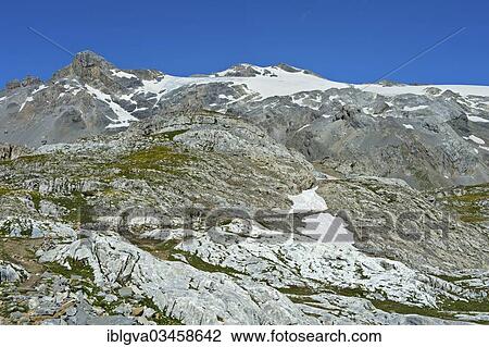 Stock Image - "Hikers in the rocky terrain below the summit of Wildhorn Mountain, Bernese Alps, Canton of Valais, Switzerland, Europe". Fotosearch