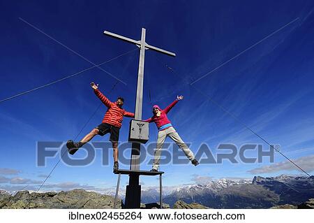 "Hikers on the summit cross on the summit of Boeses Weibele Mountain in the Defregger Group, Carnic Dolomites, Upper Lienz, Puster Valley, East Tyrol, Austria, Europe" View Large Photo Image Picture - "Hikers on the summit cross on the summit of Boeses Weibele Mountain in the Defregger Group, Carnic Dolomites, Upper Lienz, Puster Valley, East Tyrol, Austria, Europe". Fotosearch