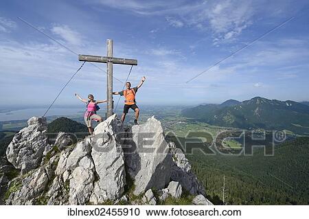 "Hikers standing next to the cross on the summit of Friedenrath mountain, Hochplatte mountain, Marquartstein, Chiemgau, Bavaria, Germany, Europe" View Large Photo Image Stock Image - "Hikers standing next to the cross on the summit of Friedenrath mountain, Hochplatte mountain, Marquartstein, Chiemgau, Bavaria, Germany, Europe". Fotosearch