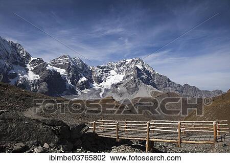 Stock Image - "Hiking trail, Mt Ortler or Mt Ortles at back on the right, and Monte Zebru, Nationalpark Stilfser Joch, South Tyrol province, Trentino-Alto Adige, Italy, Europe". Fotosearch