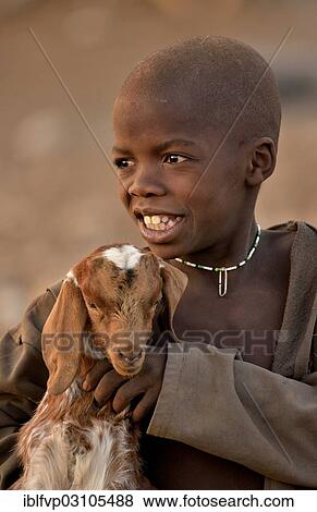 "Himba boy with a goat, Ombombo, Kaokoland, Kunene, Namibia, Africa" View Large Photo Image Stock Photo - "Himba boy with a goat, Ombombo, Kaokoland, Kunene, Namibia, Africa". Fotosearch
