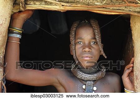 Stock Photography - "Himba girl with two braids and jewellery, portrait, Himba hut, Himba village, Kamanjab, Kunene Region, Namibia, Africa". Fotosearch