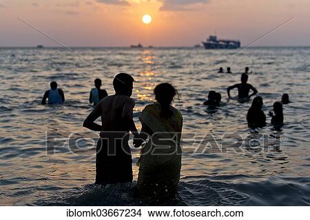 "Hindu pilgrims taking a holy bath in the sea at sunrise, at the Ghat Agni Theertham, Rameswaram, Pamban Island, Tamil Nadu, India, Asia" View Large Photo Image Picture - "Hindu pilgrims taking a holy bath in the sea at sunrise, at the Ghat Agni Theertham, Rameswaram, Pamban Island, Tamil Nadu, India, Asia". Fotosearch