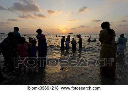"Hindu pilgrims taking a holy bath in the sea at sunrise, at the Ghat Agni Theertham, Rameswaram, Pamban Island, Tamil Nadu, India, Asia" View Large Photo Image Stock Photo - "Hindu pilgrims taking a holy bath in the sea at sunrise, at the Ghat Agni Theertham, Rameswaram, Pamban Island, Tamil Nadu, India, Asia". Fotosearch