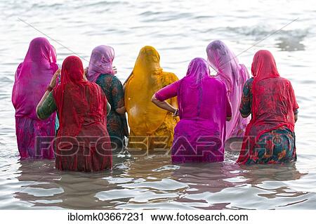 "Hindu pilgrims, women in colourful saris taking a holy bath om the sea before sunrise, at the Ghat Agni Theertham, Rameswaram, Pamban Island, Tamil Nadu, India, Asia" View Large Photo Image Stock Image - "Hindu pilgrims, women in colourful saris taking a holy bath om the sea before sunrise, at the Ghat Agni Theertham, Rameswaram, Pamban Island, Tamil Nadu, India, Asia". Fotosearch