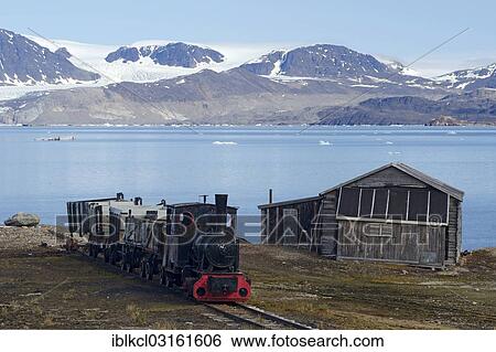 "Historic mine train in Ny Alesund against the backdrop of Kongsfjorden or Kings Bay, Kongsfjorden, Ny-Alesund, Spitsbergen Island, Svalbard Archipelago, Svalbard and Jan Mayen, Norway, Europe" View Large Photo Image Stock Photograph - "Historic mine train in Ny Alesund against the backdrop of Kongsfjorden or Kings Bay, Kongsfjorden, Ny-Alesund, Spitsbergen Island, Svalbard Archipelago, Svalbard and Jan Mayen, Norway, Europe". Fotosearch
