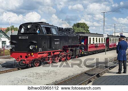 "Historic narrow gauge railway """"Molli"""" at the station of Bad Doberan, conductor in a historical uniform, Bad Doberan, Mecklenburg-Western Pomerania, Germany, Europe" View Large Photo Image Stock Image - "Historic narrow gauge railway """"Molli"""" at the station of Bad Doberan, conductor in a historical uniform, Bad Doberan, Mecklenburg-Western Pomerania, Germany, Europe". Fotosearch