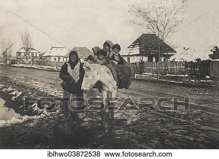 Stock Photo - "Historic photograph, ca 1914-1918, gypsy leading a donkey with four children, Vadeni village, Romania, Europe". Fotosearch
