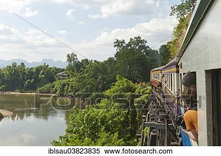 "Historic railroad, train crossing the wooden bridge, railway bridge on the Khwae Noi River or River Kwai, Tham Krasae Bridge, Wang Pho, Sai Yok District, Kanchanaburi, Kanchanaburi Province, Thailand, Asia" View Large Photo Image Stock Photography - "Historic railroad, train crossing the wooden bridge, railway bridge on the Khwae Noi River or River Kwai, Tham Krasae Bridge, Wang Pho, Sai Yok District, Kanchanaburi, Kanchanaburi Province, Thailand, Asia". Fotosearch