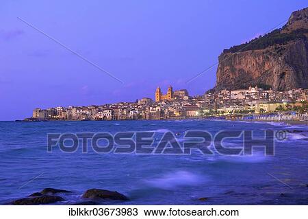 Stock Image - "Historic town centre with the Cathedral of San Salvatore and Rocca di Cefalu at dusk, Cefalu, Province of Palermo, Sicily, Italy, Europe". Fotosearch