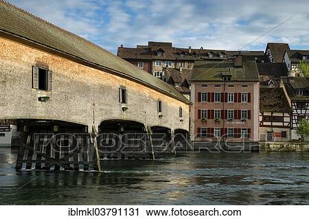 Stock Image - "Historic wooden bridge crossing the Rhine River connecting Gailingen with the Swiss Diessenhofen, Baden-Wuerttemberg, Germany, Europe". Fotosearch