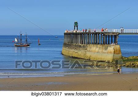 Stock Photo - "Historical excursion boat with three masts entering the harbour, Whitby, North Yorkshire, England, United Kingdom, Europe". Fotosearch