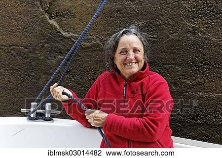 "Holidaymaker holding a rope to secure the boat in the lock chamber, houseboat on the Canal des Vosges, formerly Canal de l'Est, at PK 102. 5, Lock 7, Girancourt, Epinal, Lorraine, Departement Vosges, France, Europe" View Large Photo Image Stock Image - "Holidaymaker holding a rope to secure the boat in the lock chamber, houseboat on the Canal des Vosges, formerly Canal de l'Est, at PK 102. 5, Lock 7, Girancourt, Epinal, Lorraine, Departement Vosges, France, Europe". Fotosearch