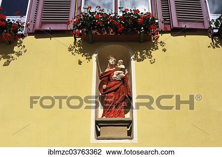 "Holy figure, """"Mary with the baby Jesus"""", in a niche in a former patrician house, Dinkelsbuhl, Middle Franconia, Bavaria, Germany, Europe" View Large Photo Image Stock Image - "Holy figure, """"Mary with the baby Jesus"""", in a niche in a former patrician house, Dinkelsbuhl, Middle Franconia, Bavaria, Germany, Europe". Fotosearch