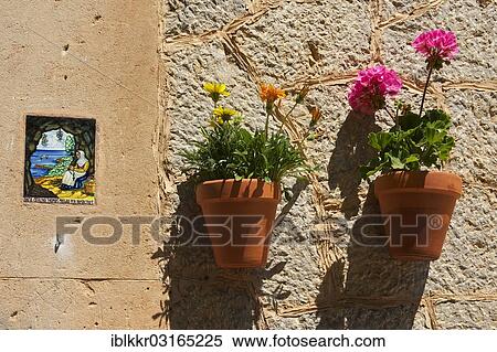 "Holy image and a flower pots on a house wall, Valldemossa, Majorca, Balearic Islands, Spain, Europe" View Large Photo Image Stock Photography - "Holy image and a flower pots on a house wall, Valldemossa, Majorca, Balearic Islands, Spain, Europe". Fotosearch