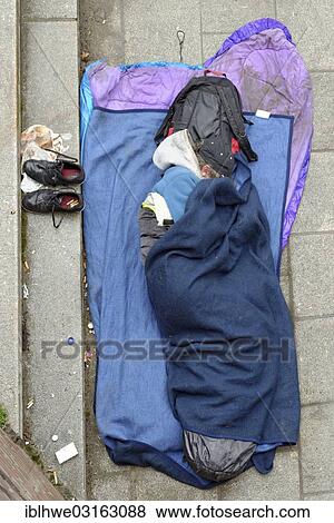 "Homeless man sleeping on the ground, Hamburg, Hamburg, Germany, Europe" View Large Photo Image Stock Photo - "Homeless man sleeping on the ground, Hamburg, Hamburg, Germany, Europe". Fotosearch