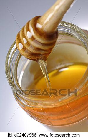 Honey spoon in a jar of honey View Large Photo Image Stock Photograph - Honey spoon in a jar of honey. Fotosearch
