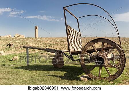 Stock Image - "Horse cart in front of the ruins of the former University of Harran, Sanliurfa province, Eastern Turkey". Fotosearch