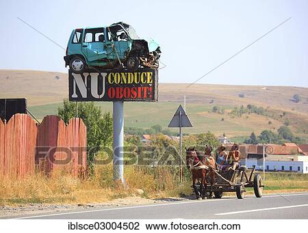 "Horse-drawn carriage in traffic, a car wreck is mounted on a pole with a warning sign, Rupea, Siebenburgen, Romania, Europe" View Large Photo Image Stock Image - "Horse-drawn carriage in traffic, a car wreck is mounted on a pole with a warning sign, Rupea, Siebenburgen, Romania, Europe". Fotosearch